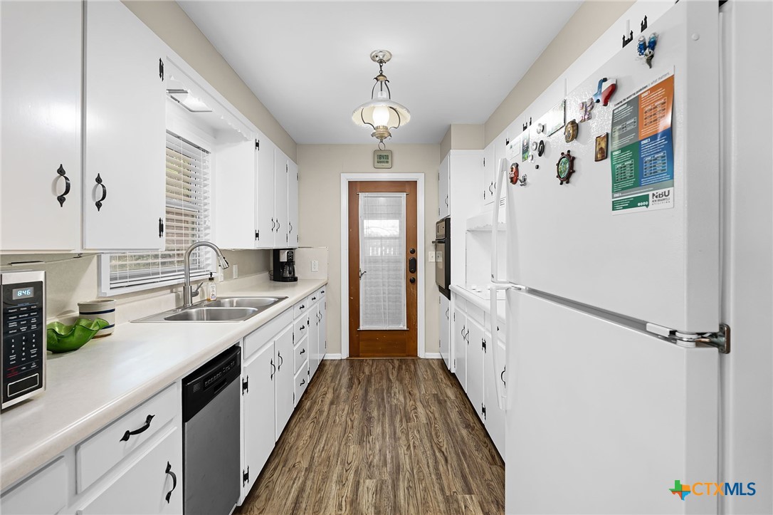 2052 Gruene Road New Braunfels, TX 78130 - Photo 15 of 33 a large kitchen with a lot of white cabinets