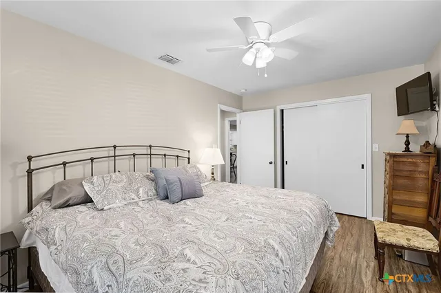 a large bed sitting in a bedroom and a flat tv screen