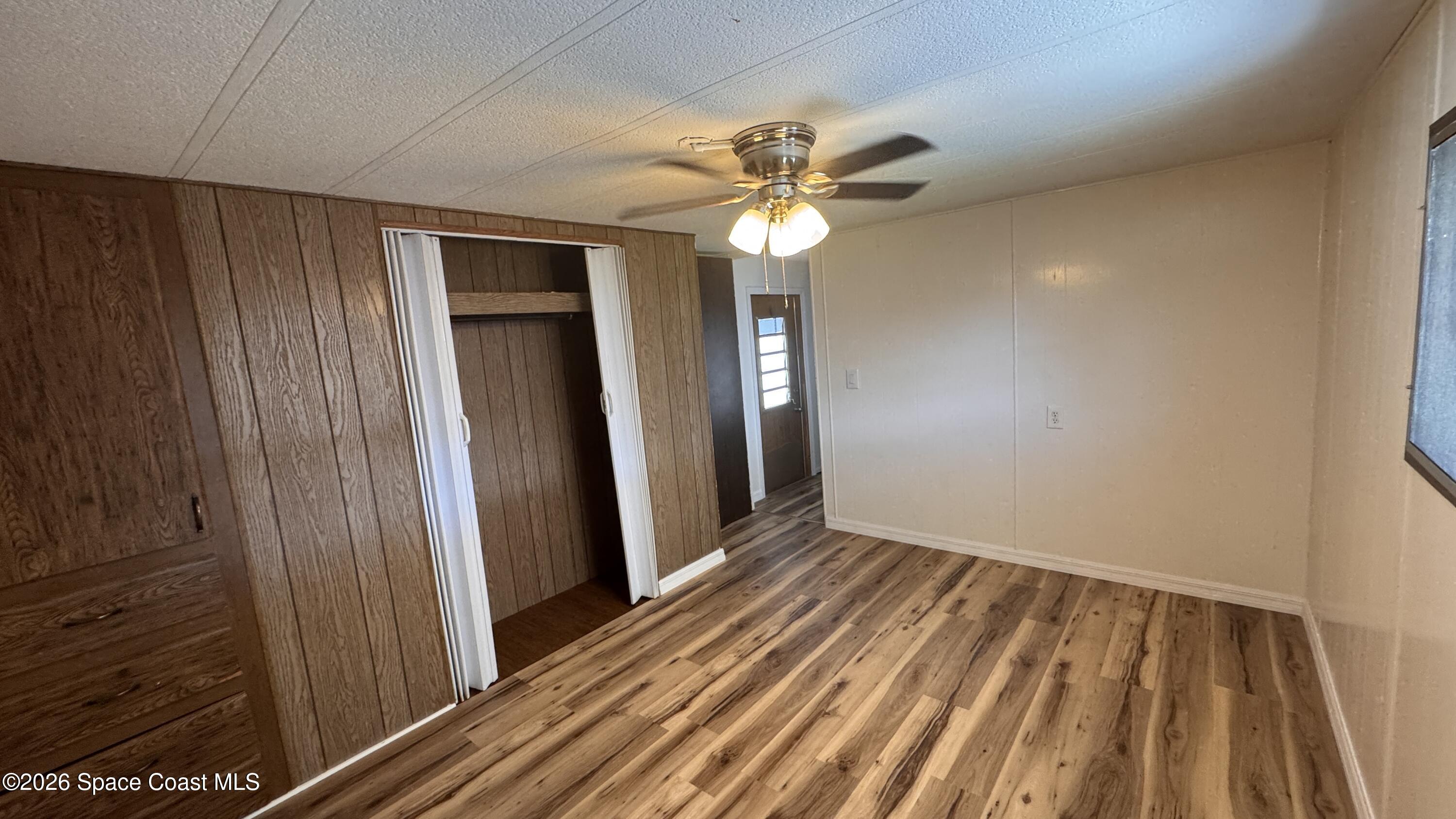 2522 Amberly Road Northeast Palm Bay, FL 32905 - Photo 7 of 13 a view of a hallway with a chandelier fan