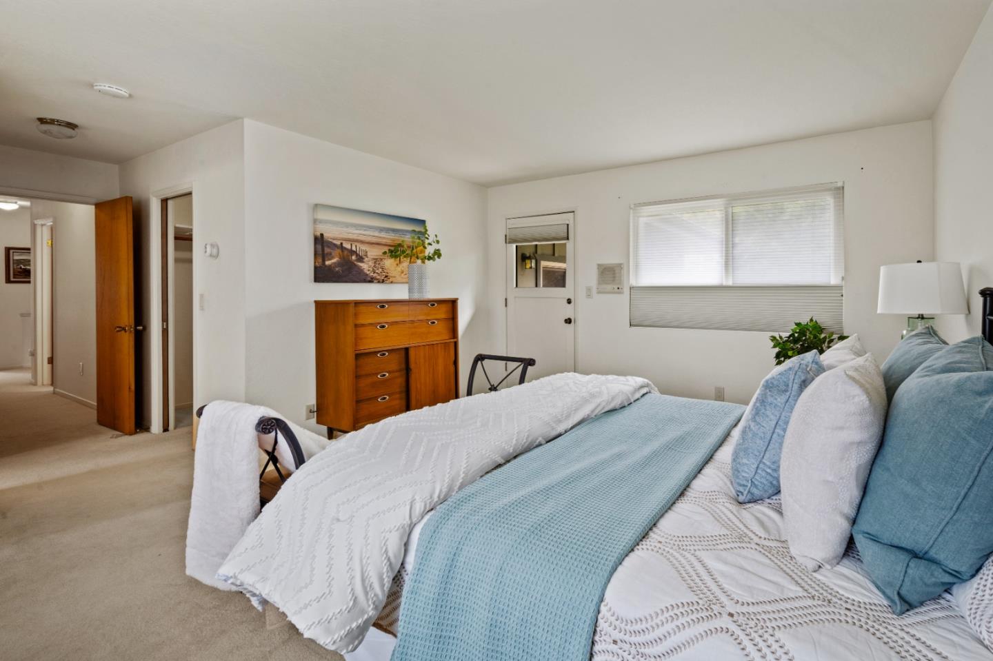 1088 Indian Village Road Pebble Beach, CA 93953 - Photo 14 of 22 a bedroom with a bed and dresser with wooden floor