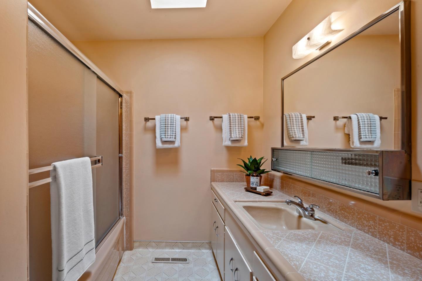 1088 Indian Village Road Pebble Beach, CA 93953 - Photo 19 of 22 a bathroom with a sink and a mirror