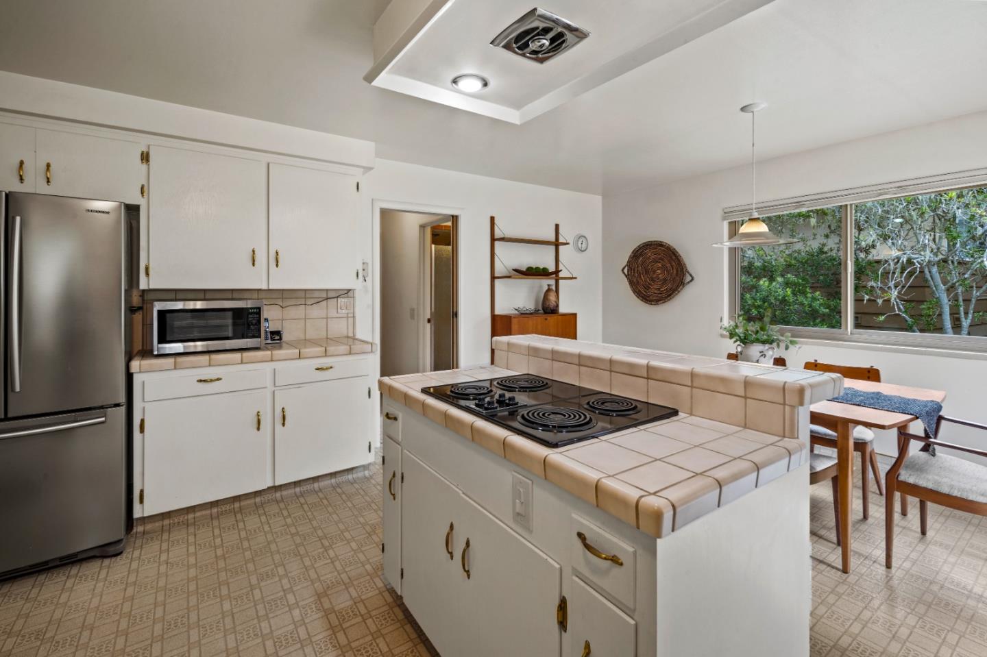 1088 Indian Village Road Pebble Beach, CA 93953 - Photo 7 of 22 a kitchen with granite countertop a stove and a refrigerator