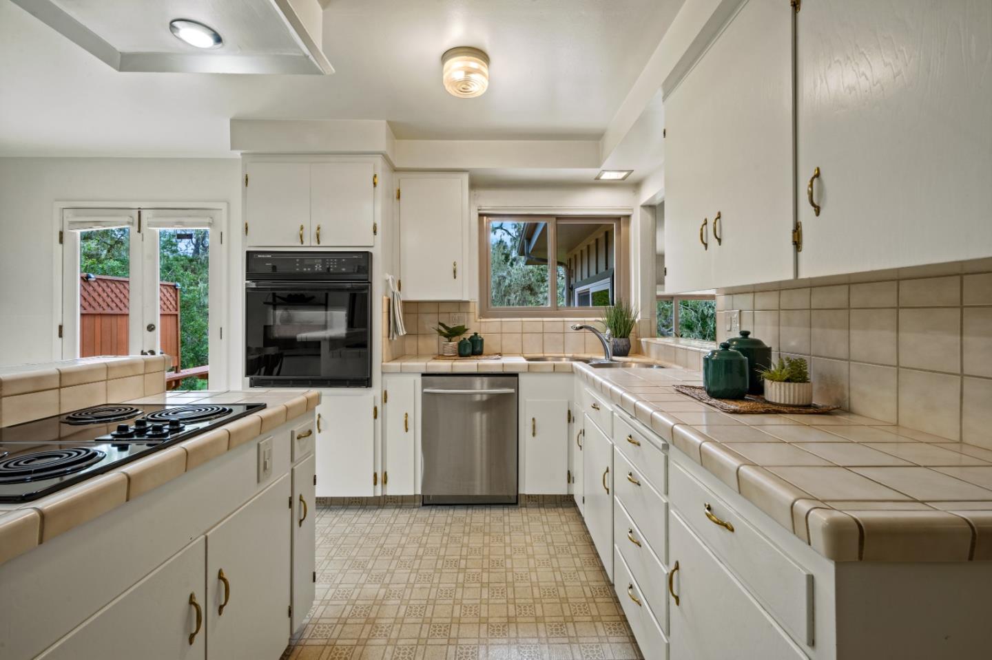 1088 Indian Village Road Pebble Beach, CA 93953 - Photo 8 of 22 a kitchen with a stove sink and cabinets