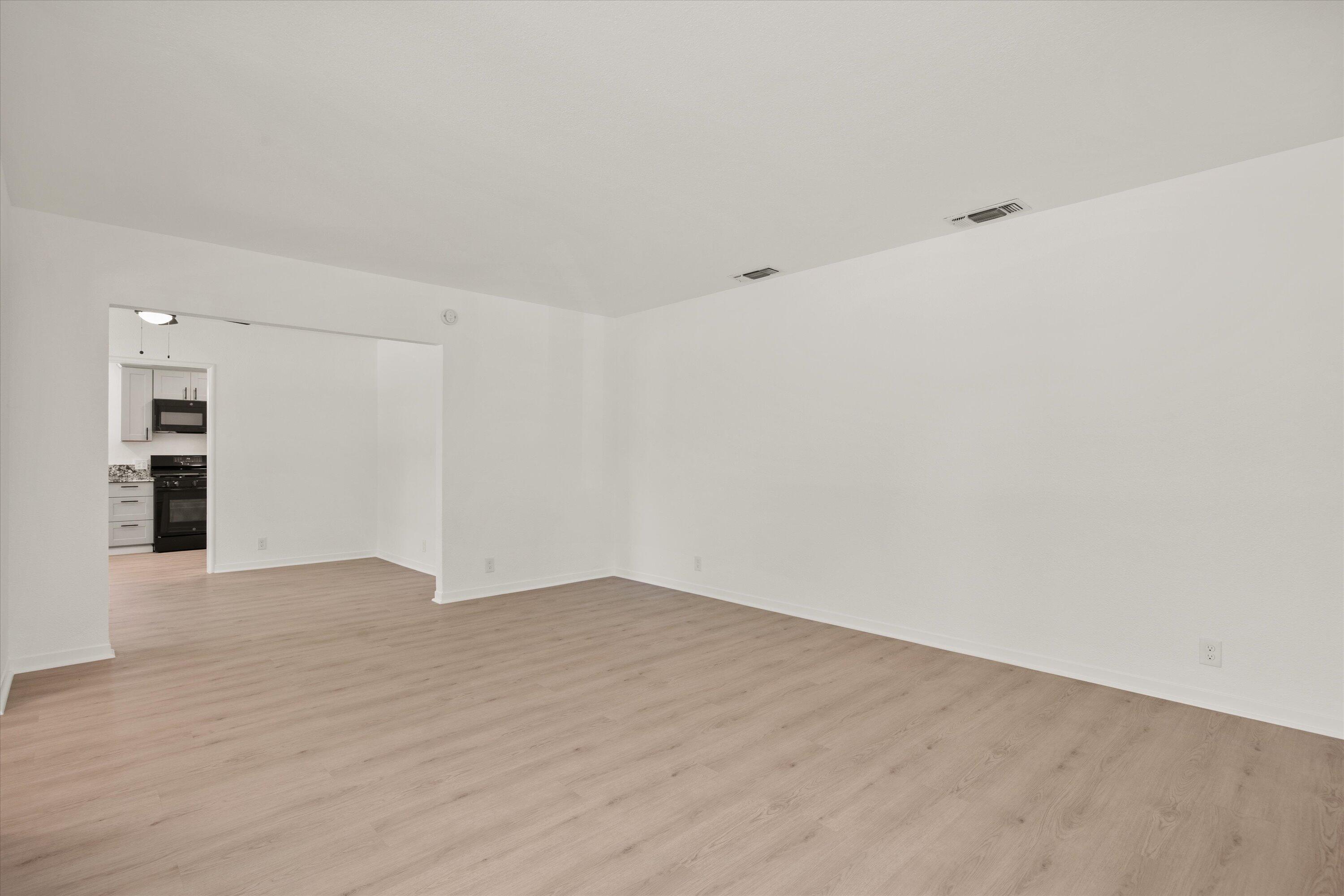 1709 Arcadian Avenue Chico, CA 95926 - Photo 12 of 33 a view of an empty room with wooden floor and kitchen