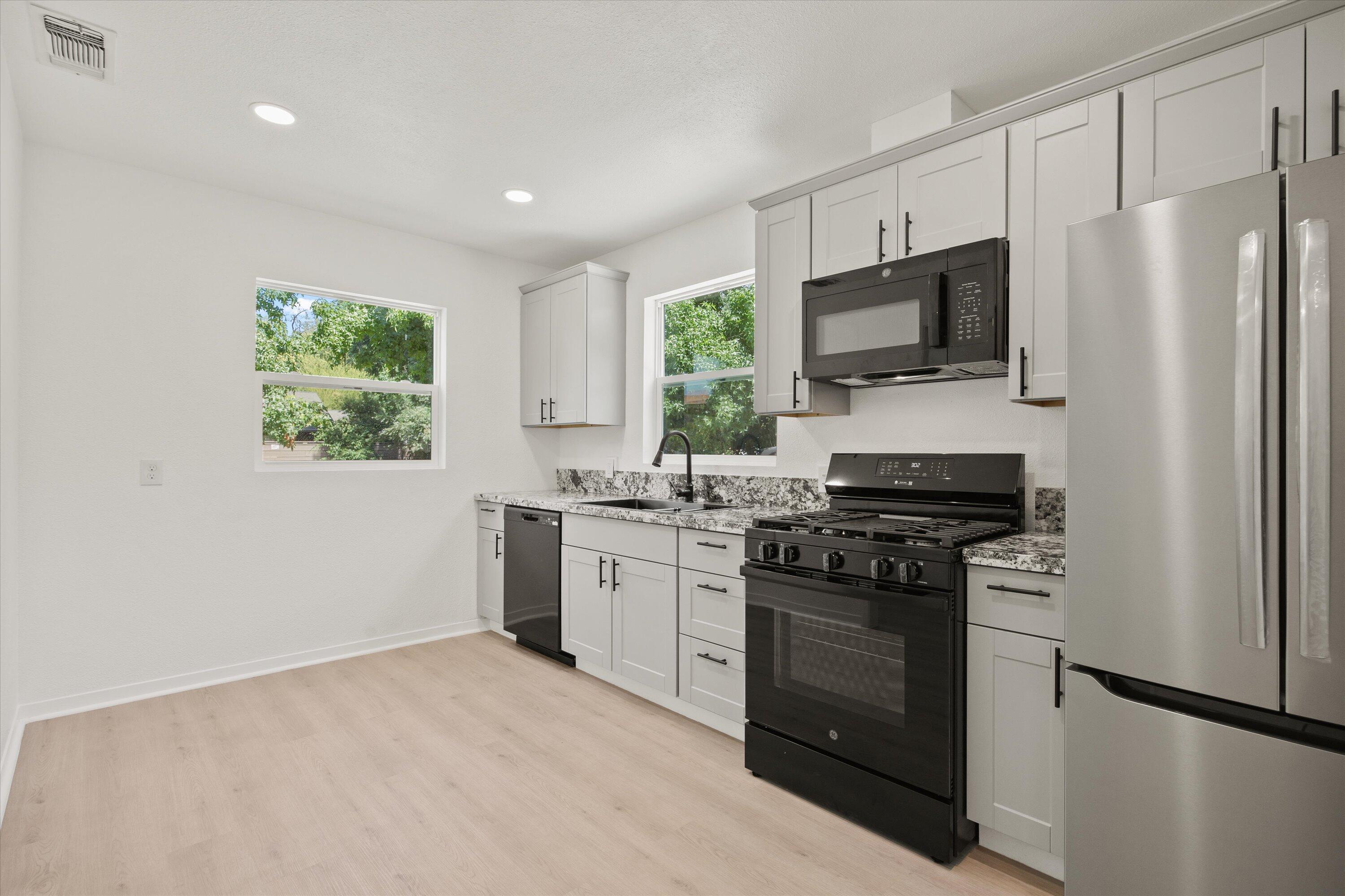 1709 Arcadian Avenue Chico, CA 95926 - Photo 19 of 33 a kitchen with a stove a sink and a microwave