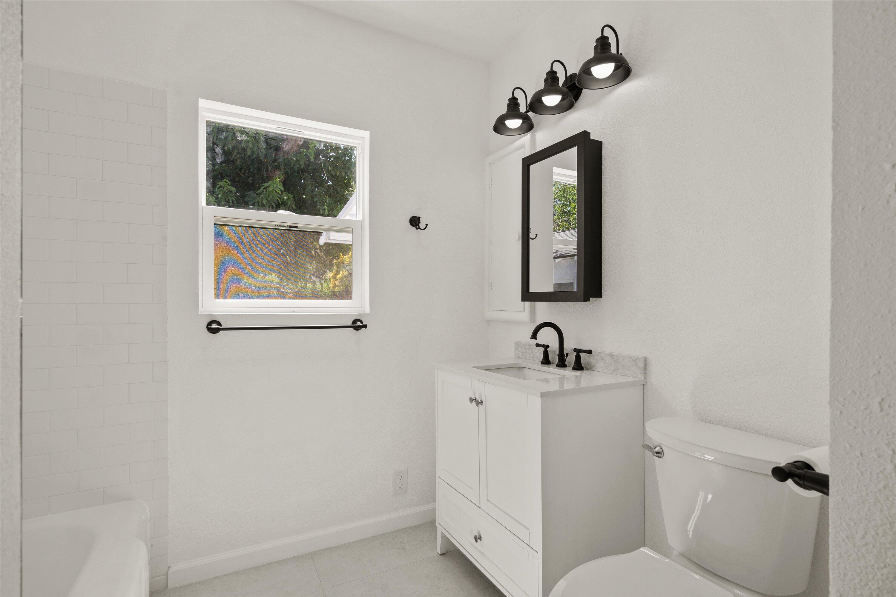 1709 Arcadian Avenue Chico, CA 95926 - Photo 21 of 33 a bathroom with a toilet sink and mirror