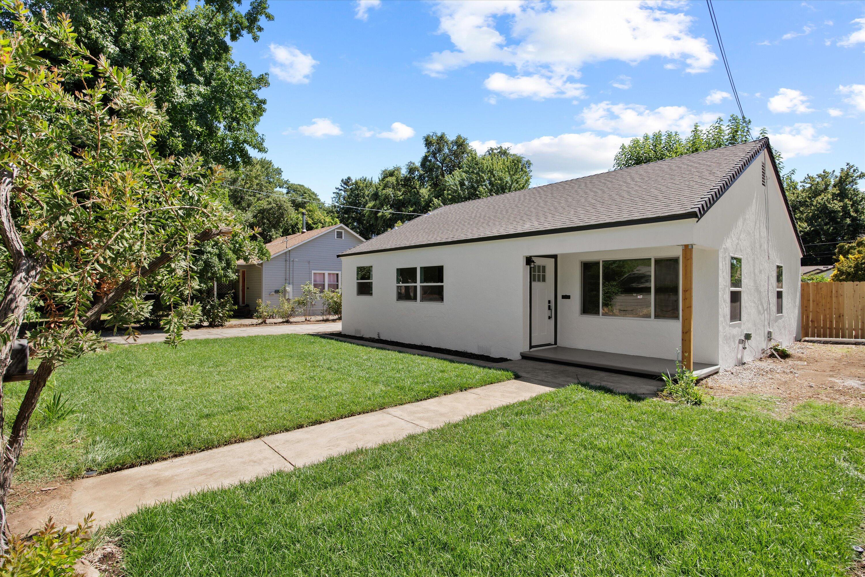 1709 Arcadian Avenue Chico, CA 95926 - Photo 6 of 33 a view of a white house in front of a yard with potted plants