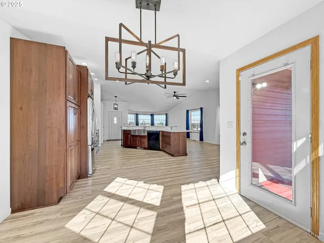 a view of a hallway with a couch and chandelier