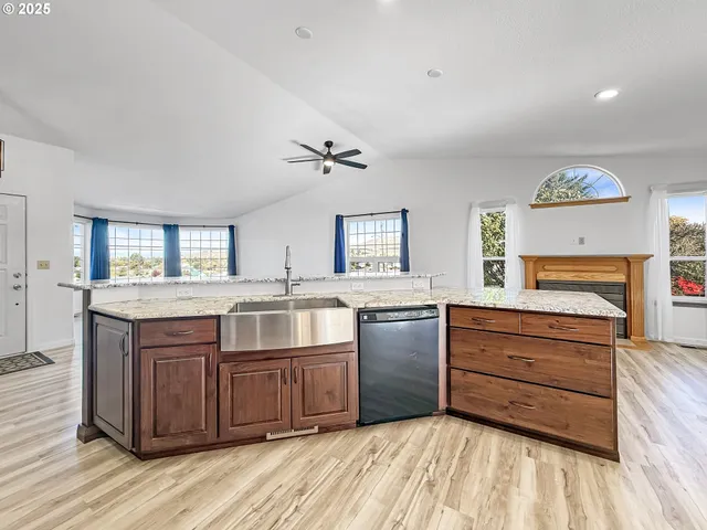 a kitchen with granite countertop a stove and cabinets