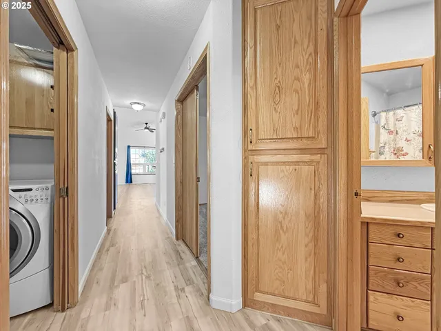 a view of a hallway with wooden floor