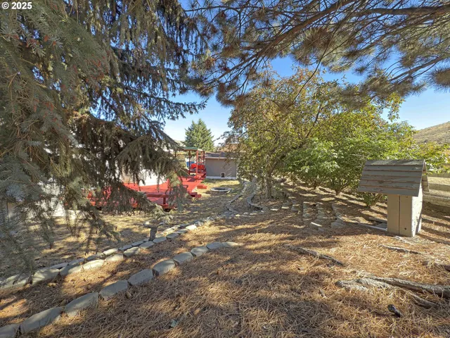 a backyard of a house with table and chairs