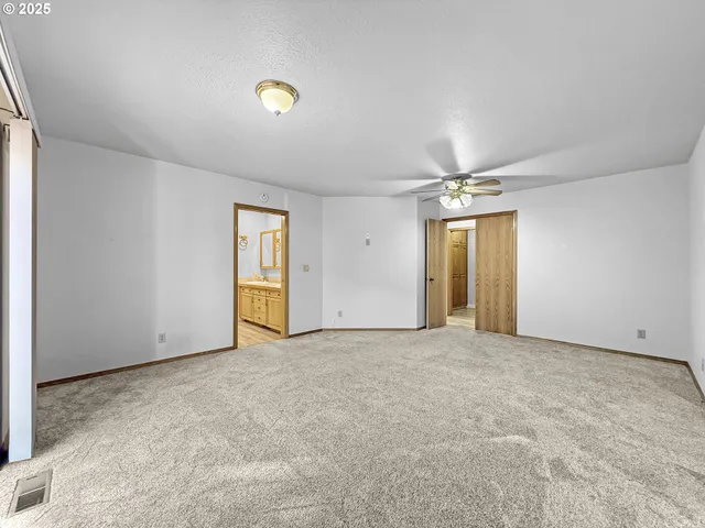 a spacious bathroom with a double vanity sink a mirror and a shower