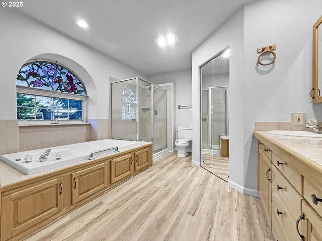 a spacious bathroom with a granite countertop sink mirror and toilet