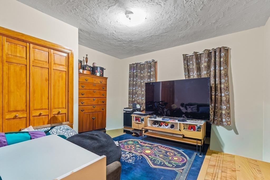74 Forest Street Whitman, MA 02382 - Photo 12 of 32 a living room with furniture and a flat screen tv