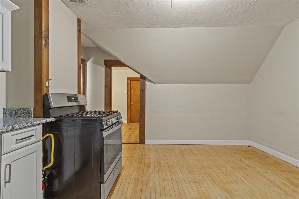 74 Forest Street Whitman, MA 02382 - Photo 17 of 32 a kitchen with a stove and a refrigerator