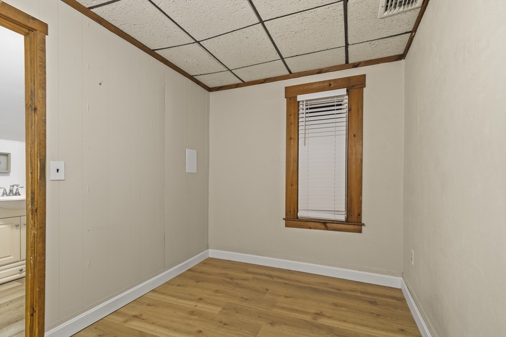 74 Forest Street Whitman, MA 02382 - Photo 18 of 32 a view of an empty room with wooden floor and a window