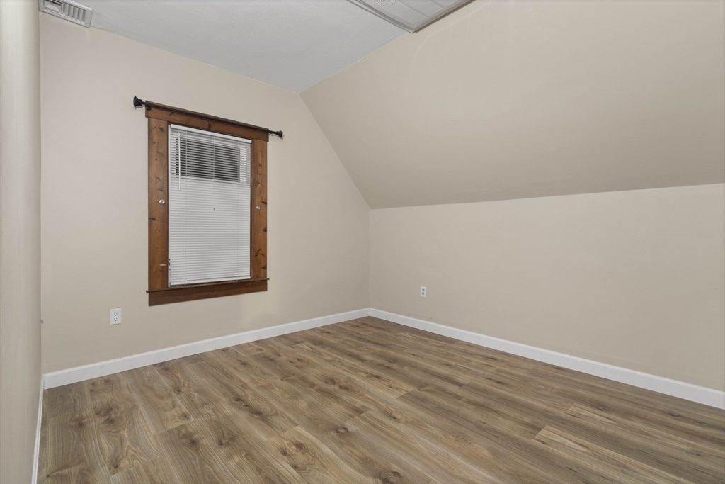 74 Forest Street Whitman, MA 02382 - Photo 22 of 32 a view of an empty room with wooden floor and a window