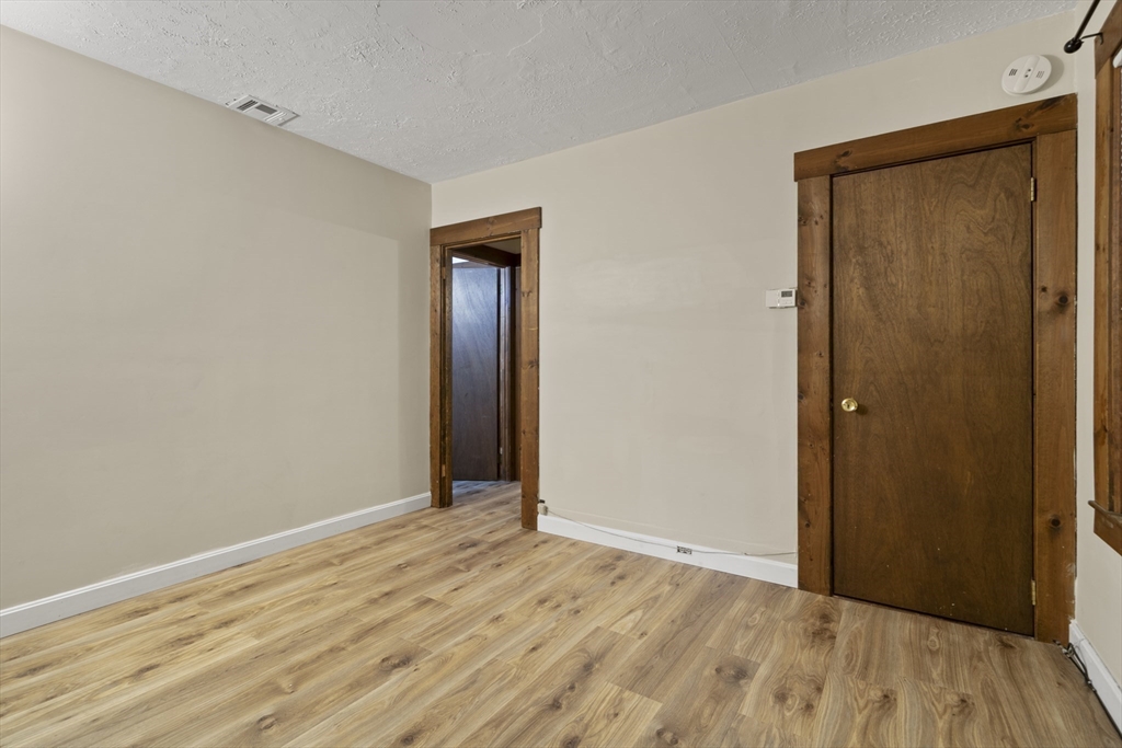 74 Forest Street Whitman, MA 02382 - Photo 25 of 32 a view of an empty room with wooden floor and closet