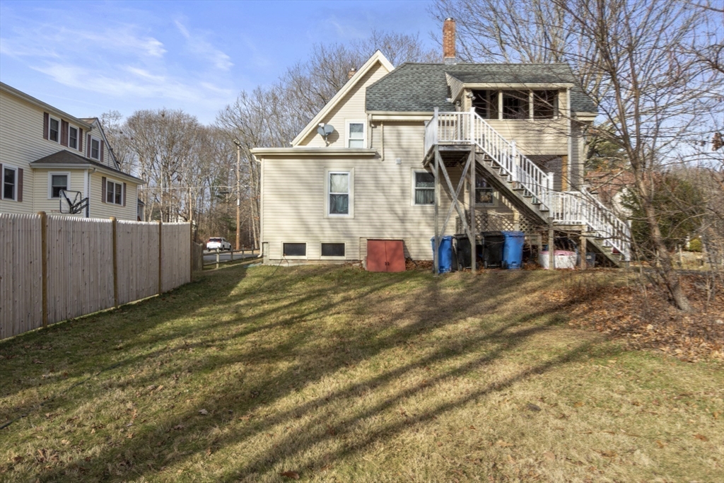 74 Forest Street Whitman, MA 02382 - Photo 29 of 32 a view of a white house with a yard and wooden fence