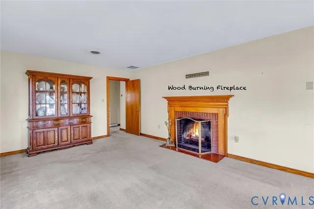 an empty room with fireplace and windows