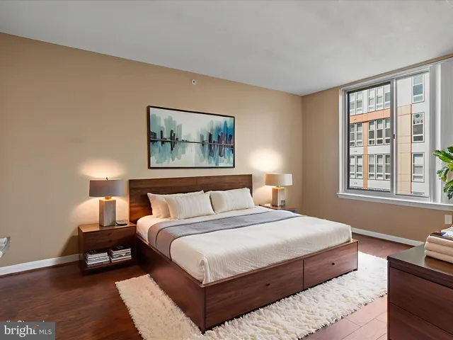 a bedroom with a bed a couch and a window