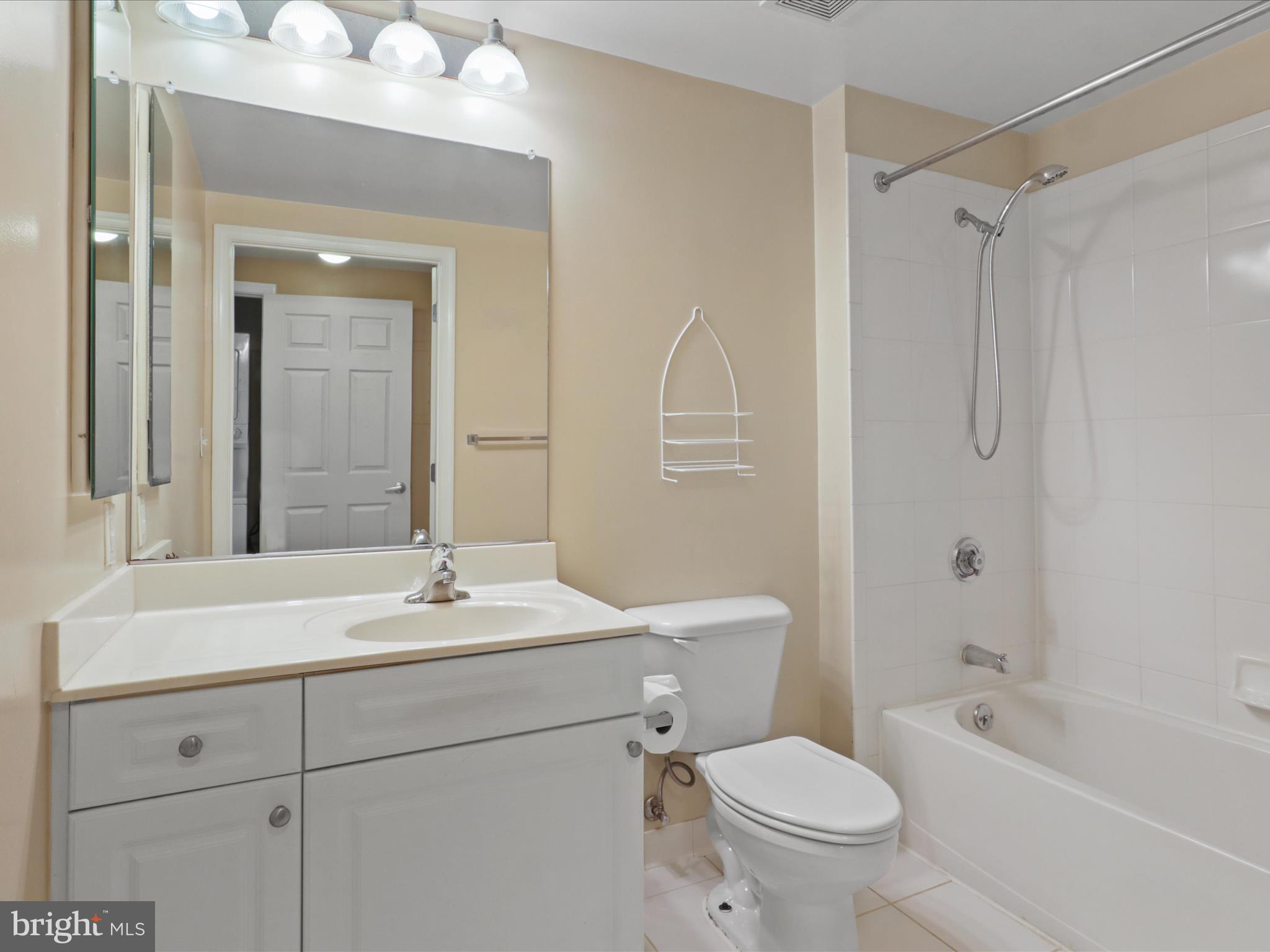 2726 Gallows Road, Unit 411 Vienna, VA 22180 - Photo 15 of 36 a bathroom with a sink a toilet and shower