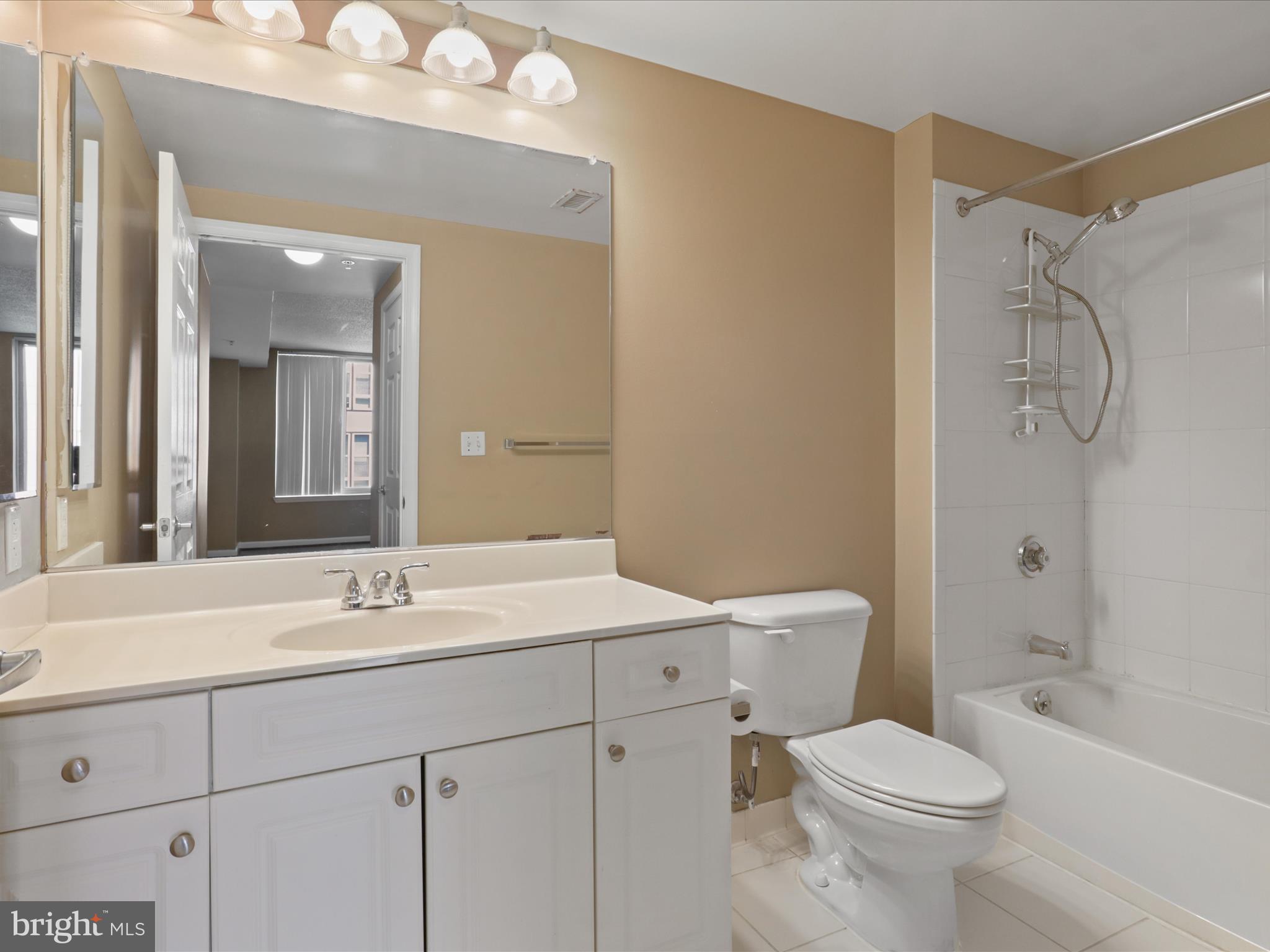 2726 Gallows Road, Unit 411 Vienna, VA 22180 - Photo 17 of 36 a bathroom with a sink a toilet and shower