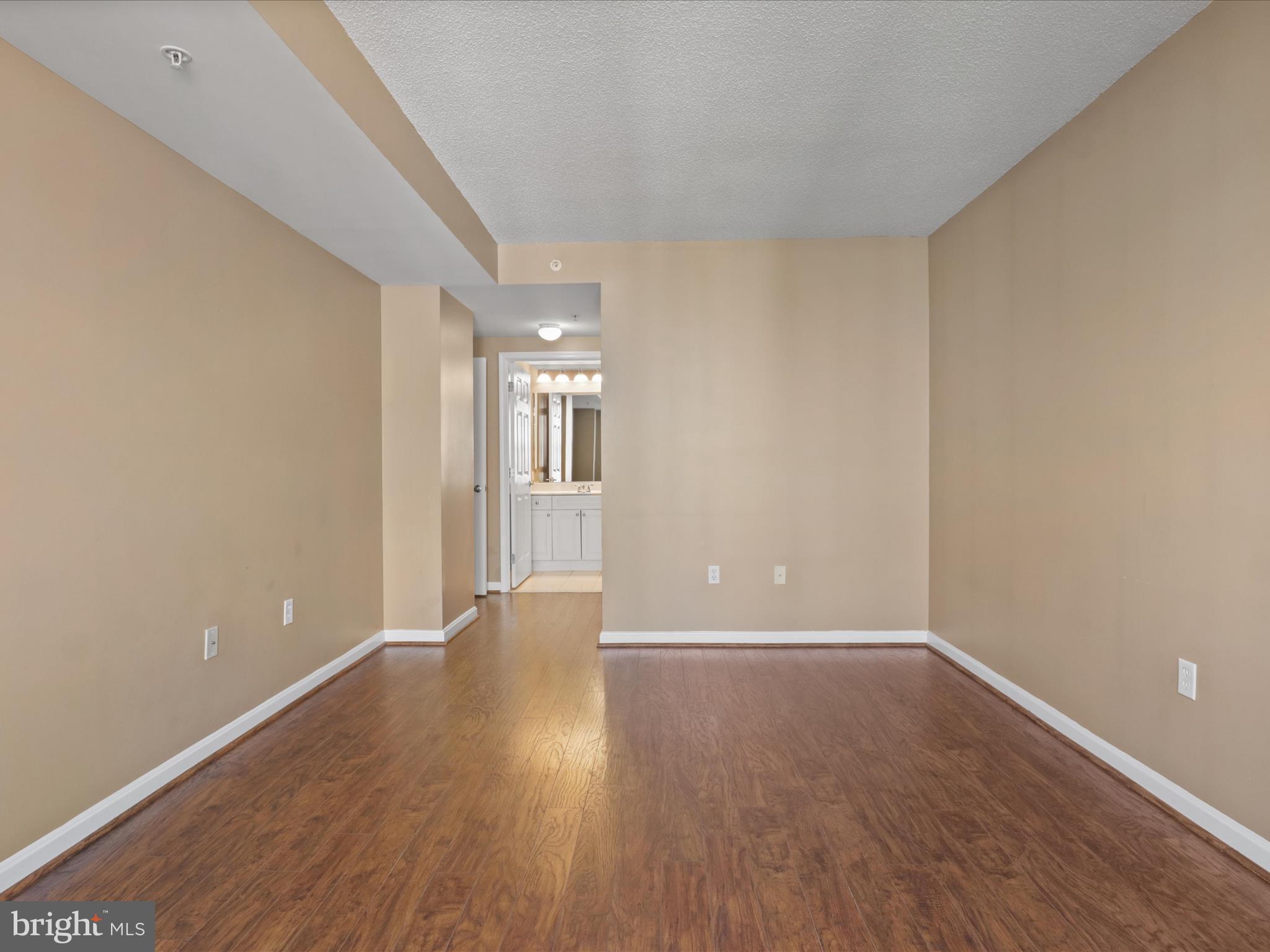2726 Gallows Road, Unit 411 Vienna, VA 22180 - Photo 22 of 36 wooden floor in an empty room with a window