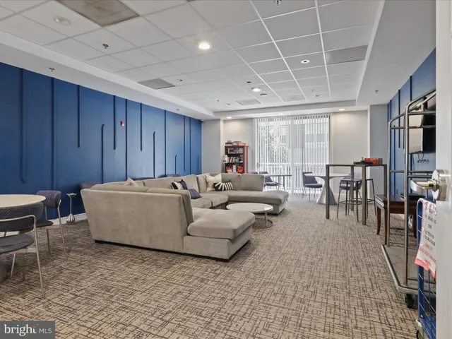 a living room with furniture a dining table and a flat screen tv