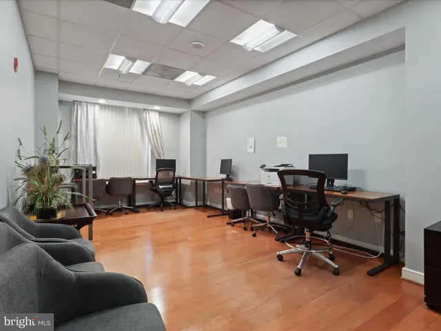 a view of a livingroom with workspace and a window
