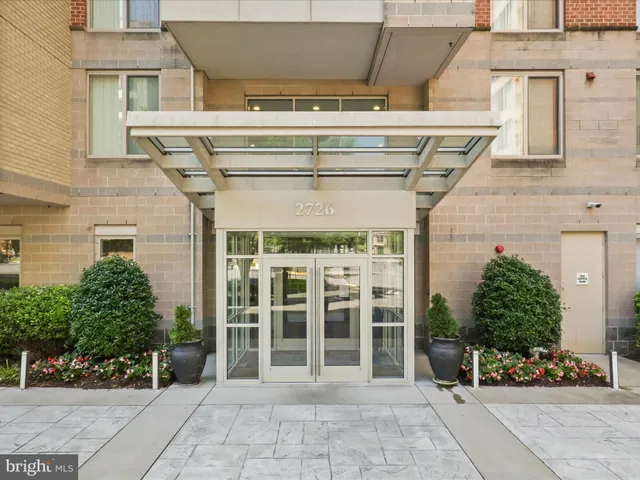 front view of a building with a garden