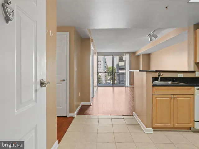 a view of a kitchen with refrigerator and windows