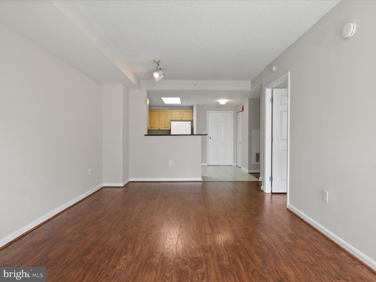 2726 Gallows Road, Unit 411 Vienna, VA 22180 - Photo 8 of 36 a view of a livingroom with wooden floor and a window
