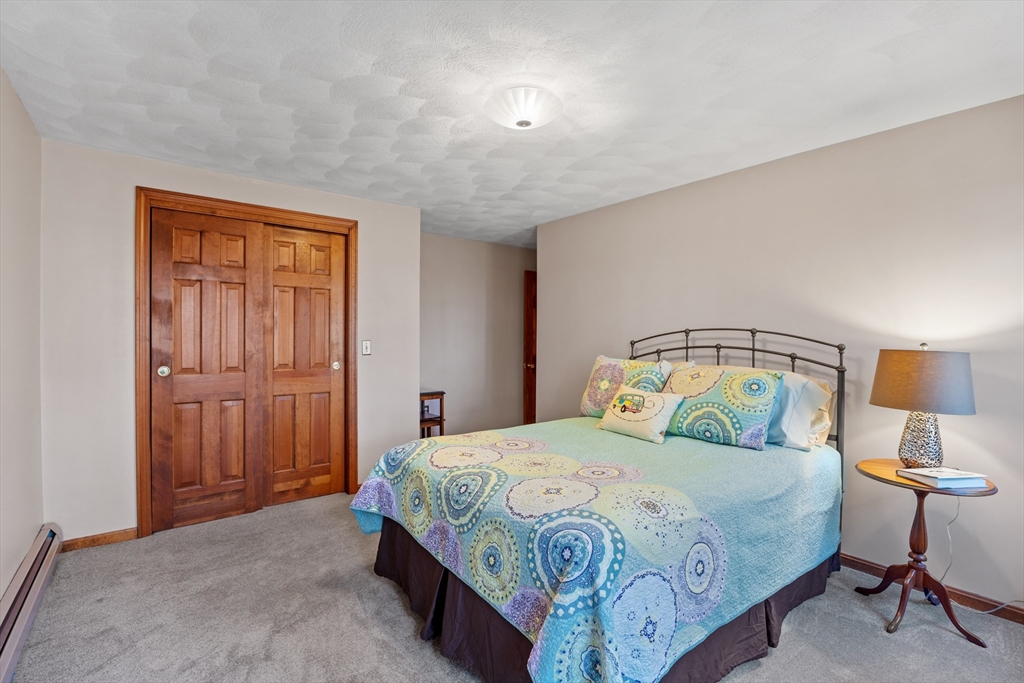 24 New Road Windham, NH 03087 - Photo 28 of 31 a bedroom with a bed and a lamp