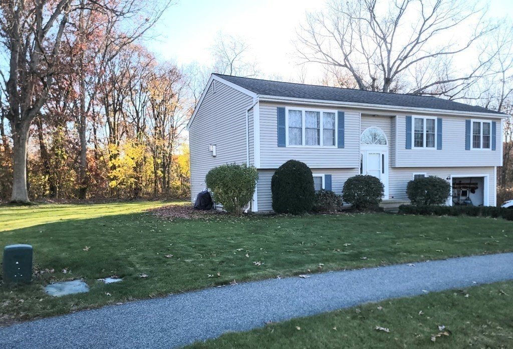 a view of a house with a backyard