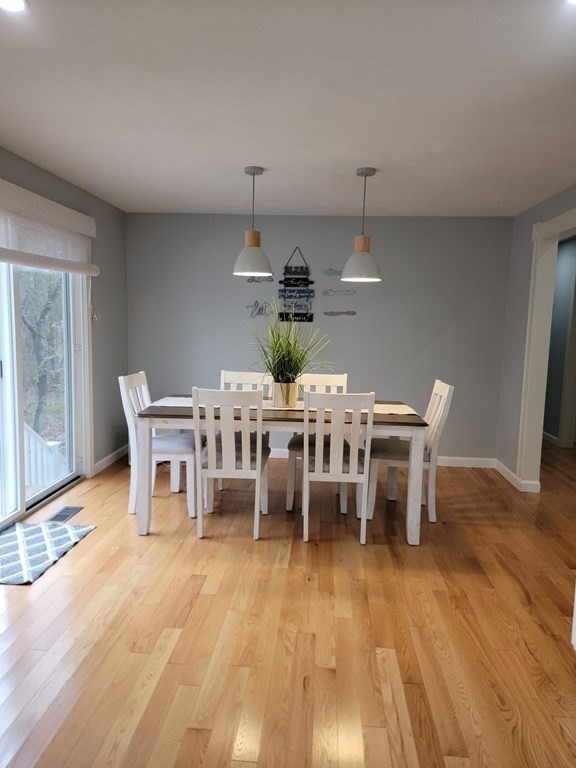 66 Vincent Circle Worcester, MA 01604 - Photo 11 of 40 a dining room with furniture a chandelier and wooden floor