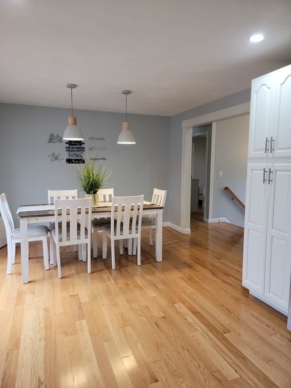 66 Vincent Circle Worcester, MA 01604 - Photo 13 of 40 a dining room with furniture a chandelier and wooden floor
