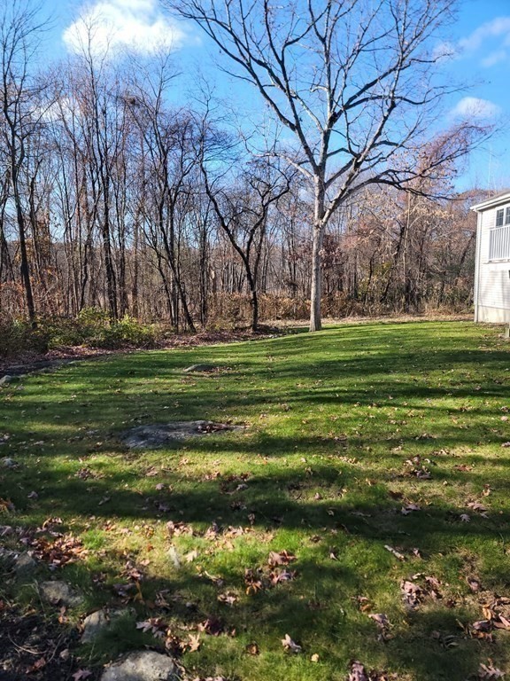 66 Vincent Circle Worcester, MA 01604 - Photo 38 of 40 a backyard of a house with a yard and outdoor seating