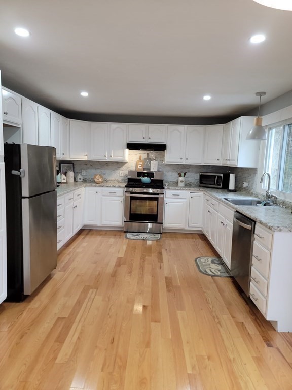 66 Vincent Circle Worcester, MA 01604 - Photo 10 of 40 a kitchen with granite countertop a refrigerator stove top oven and sink
