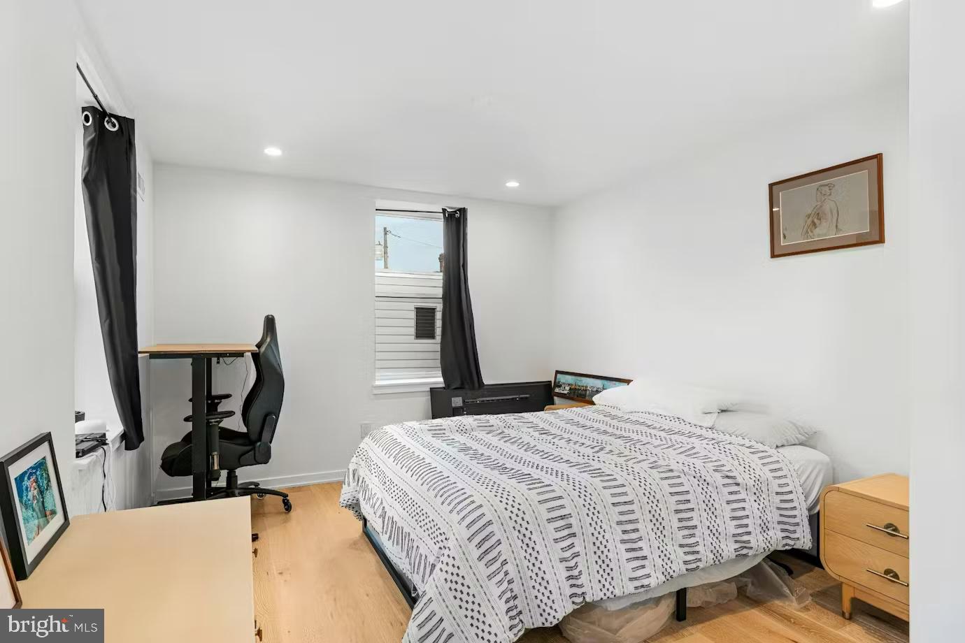 936 Tasker Street Philadelphia, PA 19148 - Photo 11 of 17 a bedroom with a bed a mirror and a flat screen tv