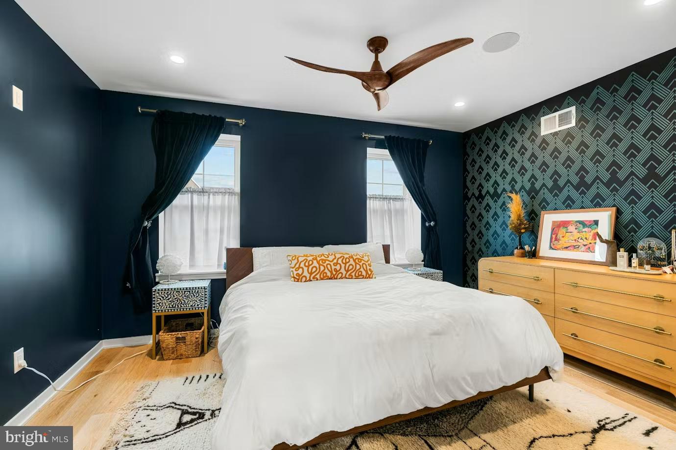 936 Tasker Street Philadelphia, PA 19148 - Photo 7 of 17 a bedroom with a bed and a large window