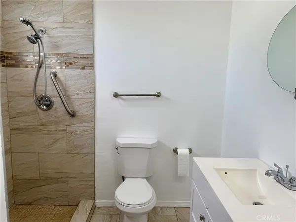 a white toilet sitting next to a bathroom sink