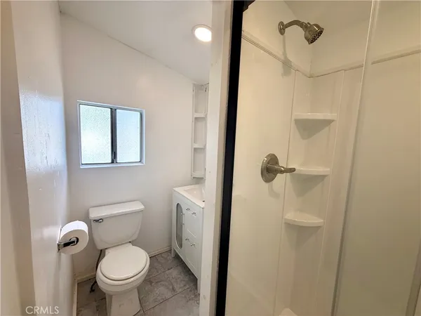 a bathroom with a toilet and a shower