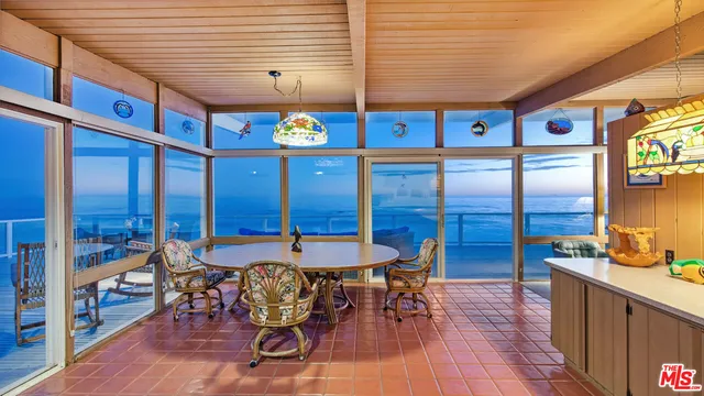 a large room with lots of wooden furniture and a chandelier