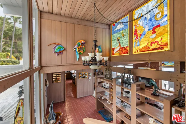 a bedroom with a bed table and chair