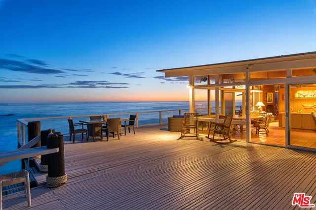 a view of a swimming pool with red chairs