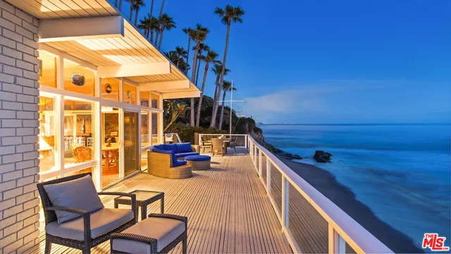an aerial view of residential house with outdoor space and trees all around