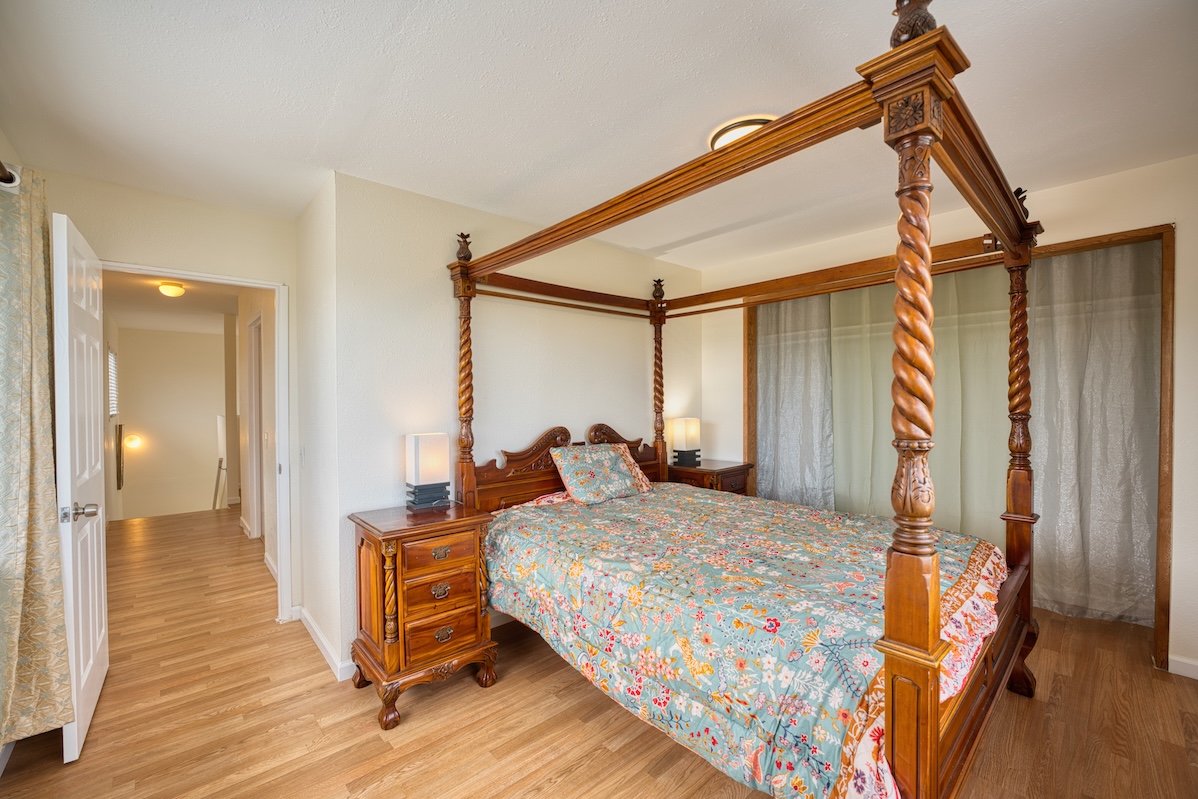 2059 Kinoole Street Hilo, HI 96720 - Photo 11 of 30 a bedroom with a bed and wooden floor