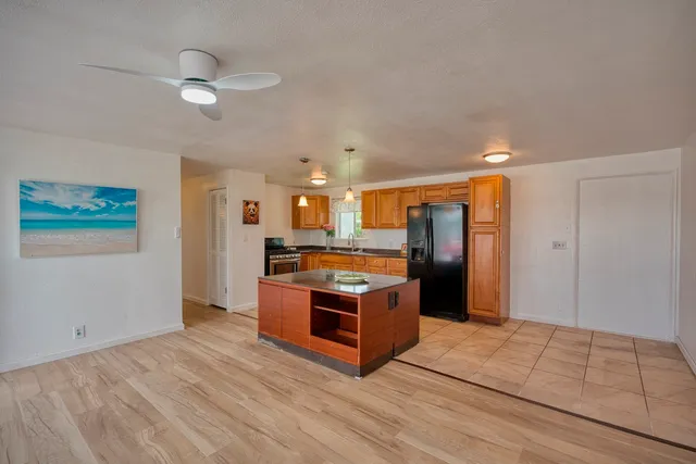 a kitchen with stainless steel appliances granite countertop a refrigerator and a sink