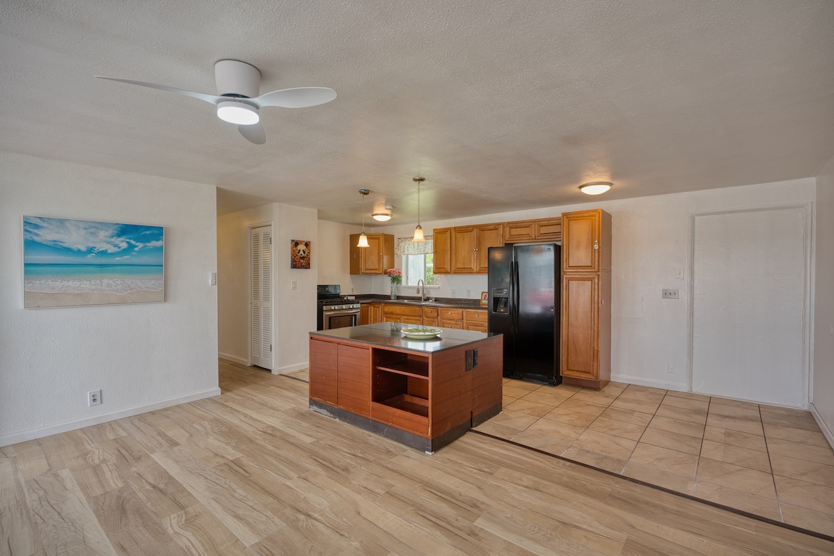2059 Kinoole Street Hilo, HI 96720 - Photo 13 of 30 a kitchen with stainless steel appliances granite countertop a refrigerator and a sink